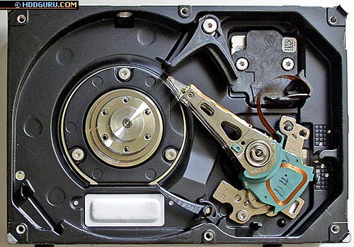 an inside structure of a position control system (Seagate Barracuda 7200.7, 160 GB): a head stack, a VCM coil, the load/unload mechanisms